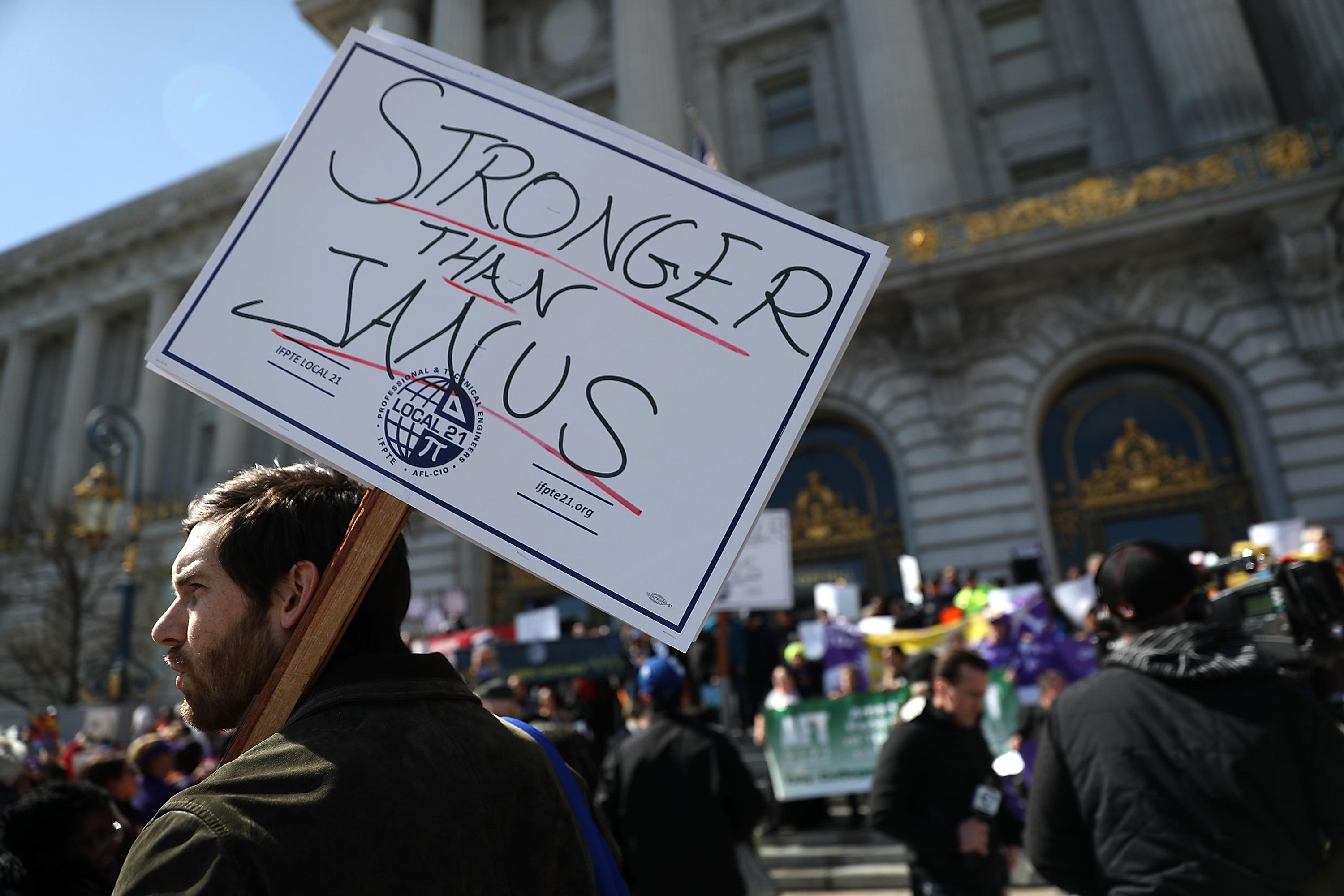 SAN FRANCISCO, CA - FEBRUARY 26:  Union members hold signs during a rally outside of San Francisco City Hall on February 26, 2018 in San Francisco, California.  Hundreds of union members held a rally outside of San Francisco City Hall as the US Supreme Court begins to hear oral arguments in the Janus V. AFSCME case that union memebers and supporters claim would limit their right to union representation by allowing members to not pay dues but still receive representation.  (Photo by Justin Sullivan/Getty Images)