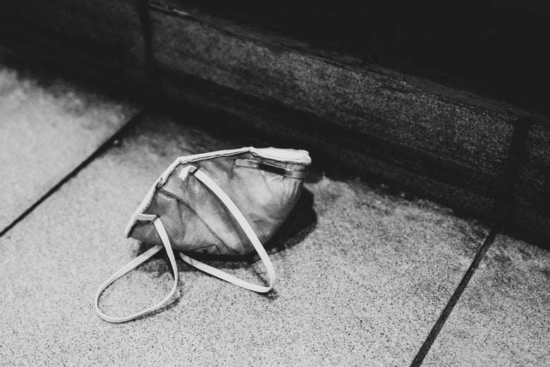 A face mask is seen on the ground.