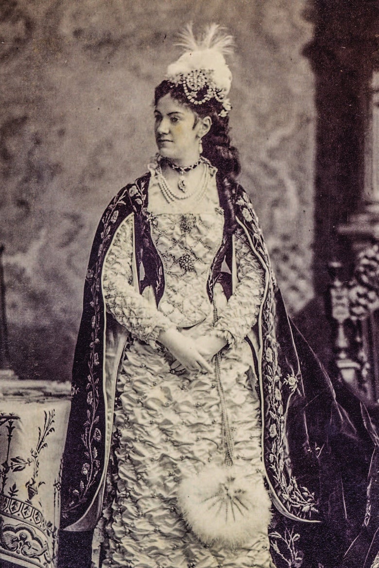 A woman wearing an elaborate gown in a portrait. 