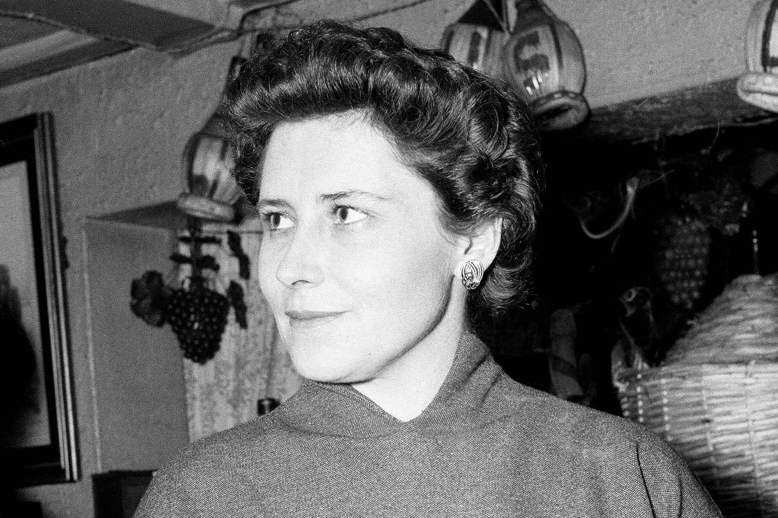 Black and white photo of a slightly smiling Lessing standing in what appears to be a kitchen
