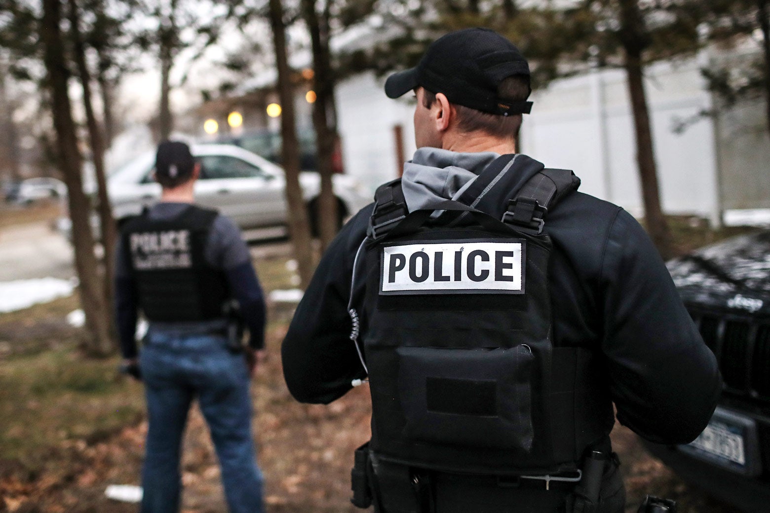 Customs and Border Protection officers stand while wearing police vests on March 29 in Brentwood, New York.
