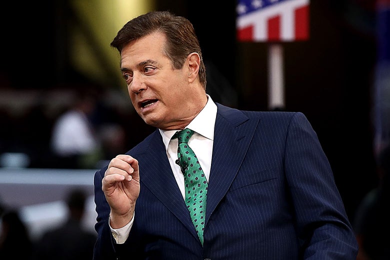 Paul Manafort leans over to talk to an interviewer.