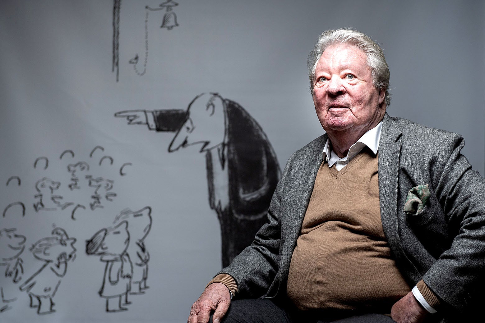 Jean-Jacques Sempe poses with cartoons of his during a photo session in Rueil-Malmaison, on Nov. 6, 2019.
