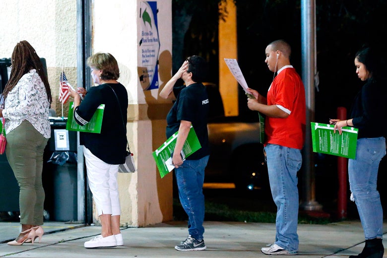 People wait in line to vote at a polling station in Miami, Florida, late on Nov. 6, 2018.