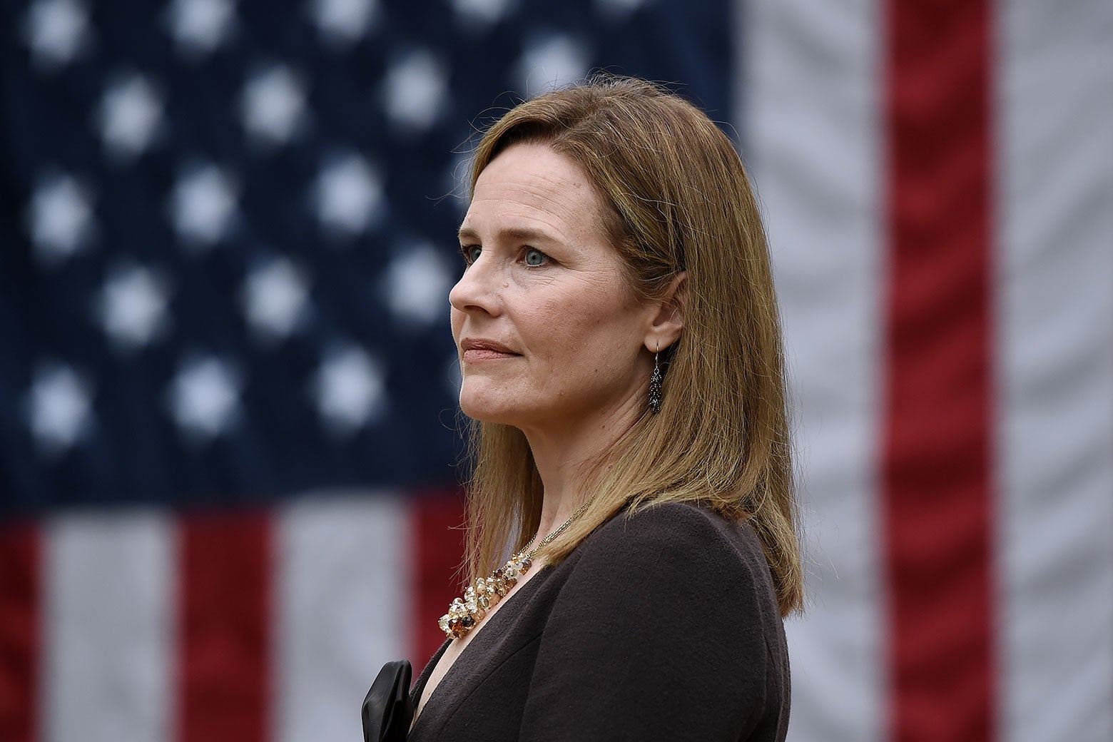 Amy Coney Barrett in front of a U.S. flag
