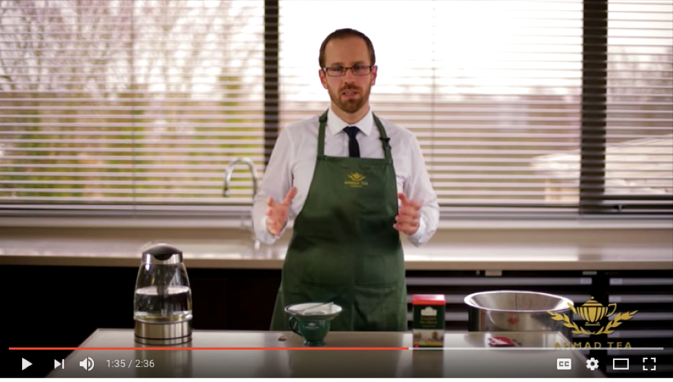 Screen capture from YouTube showing a man in an apron about to prepare food.