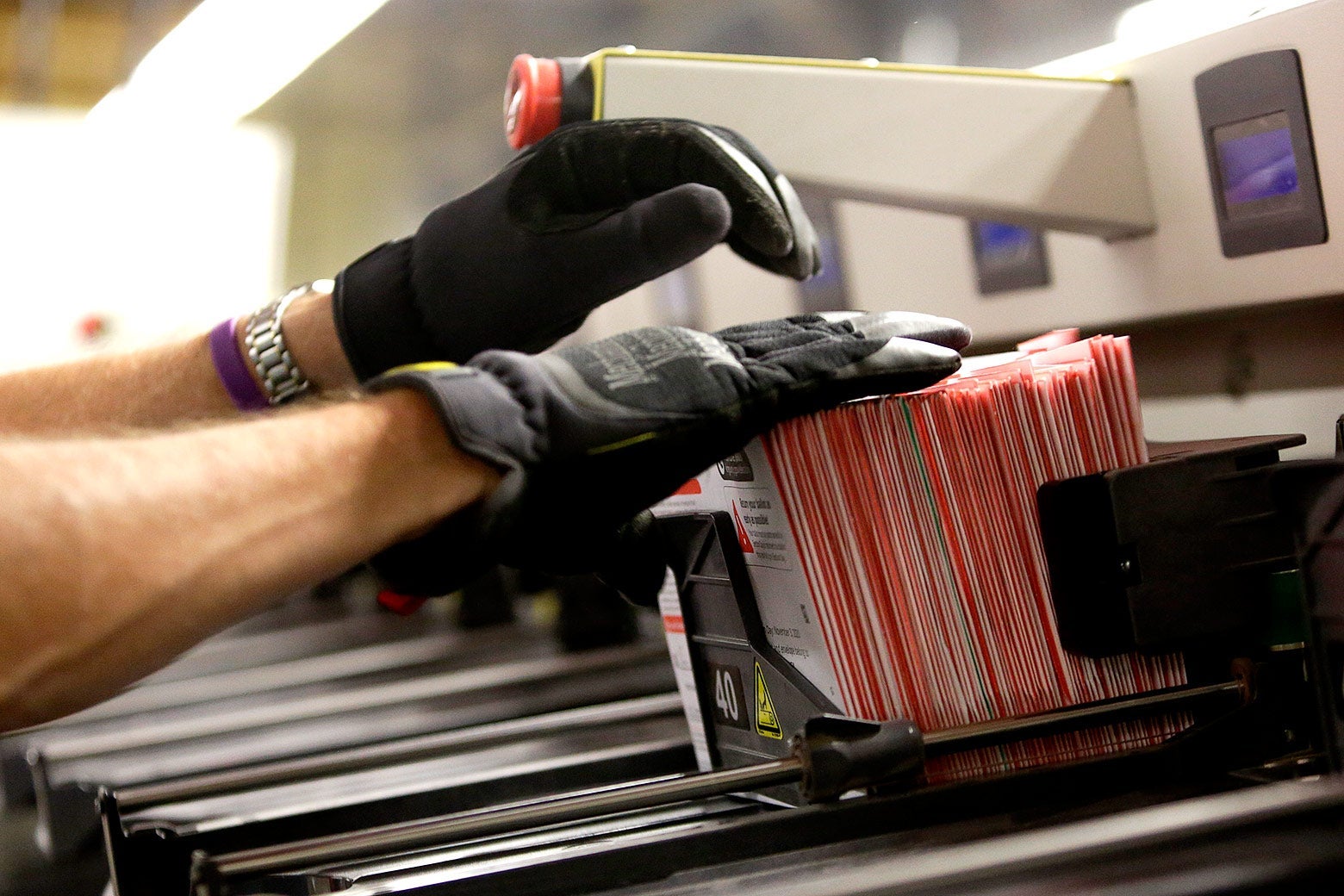 An election worker takes ballots from a sorting machine in Renton, Washington on Election Day.