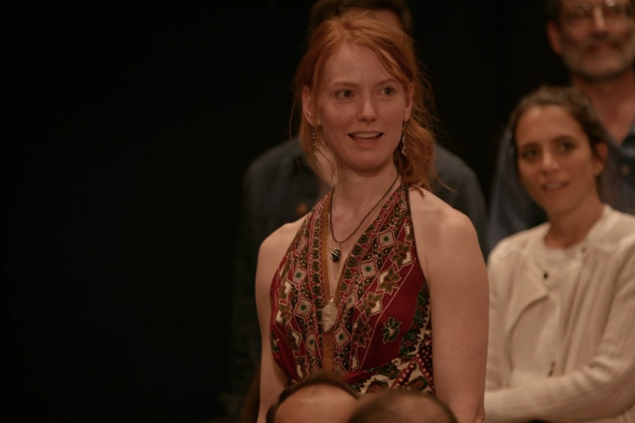 Alicia Witt, standing in a theater audience.