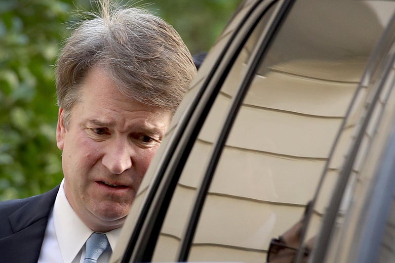 Supreme Court nominee Judge Brett Kavanaugh appears behind the side of a car, looking anxious