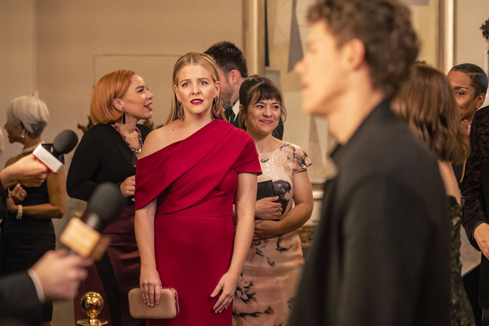 Brooke wearing a red dress, looking dismayed.