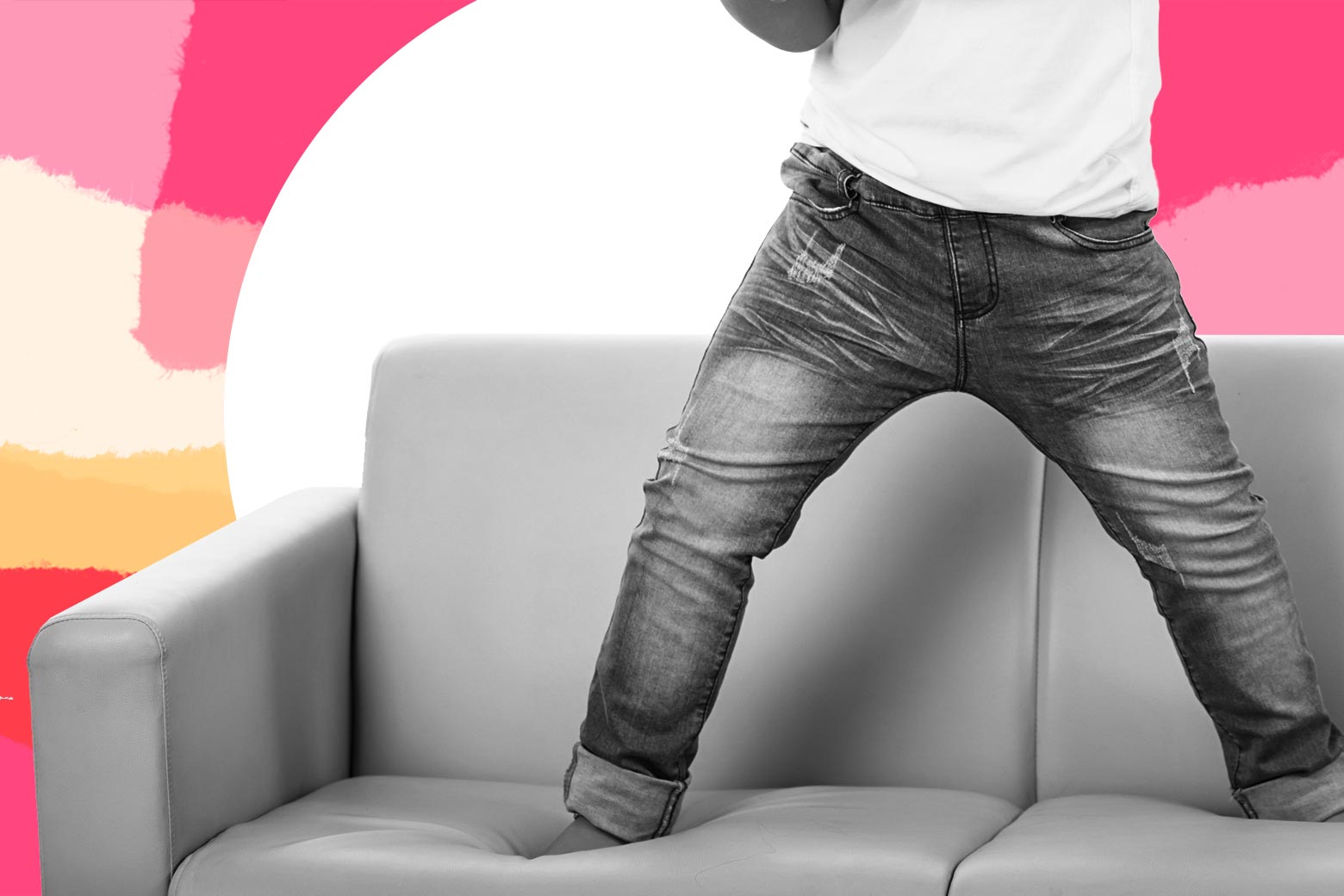 A child jumps on a couch.