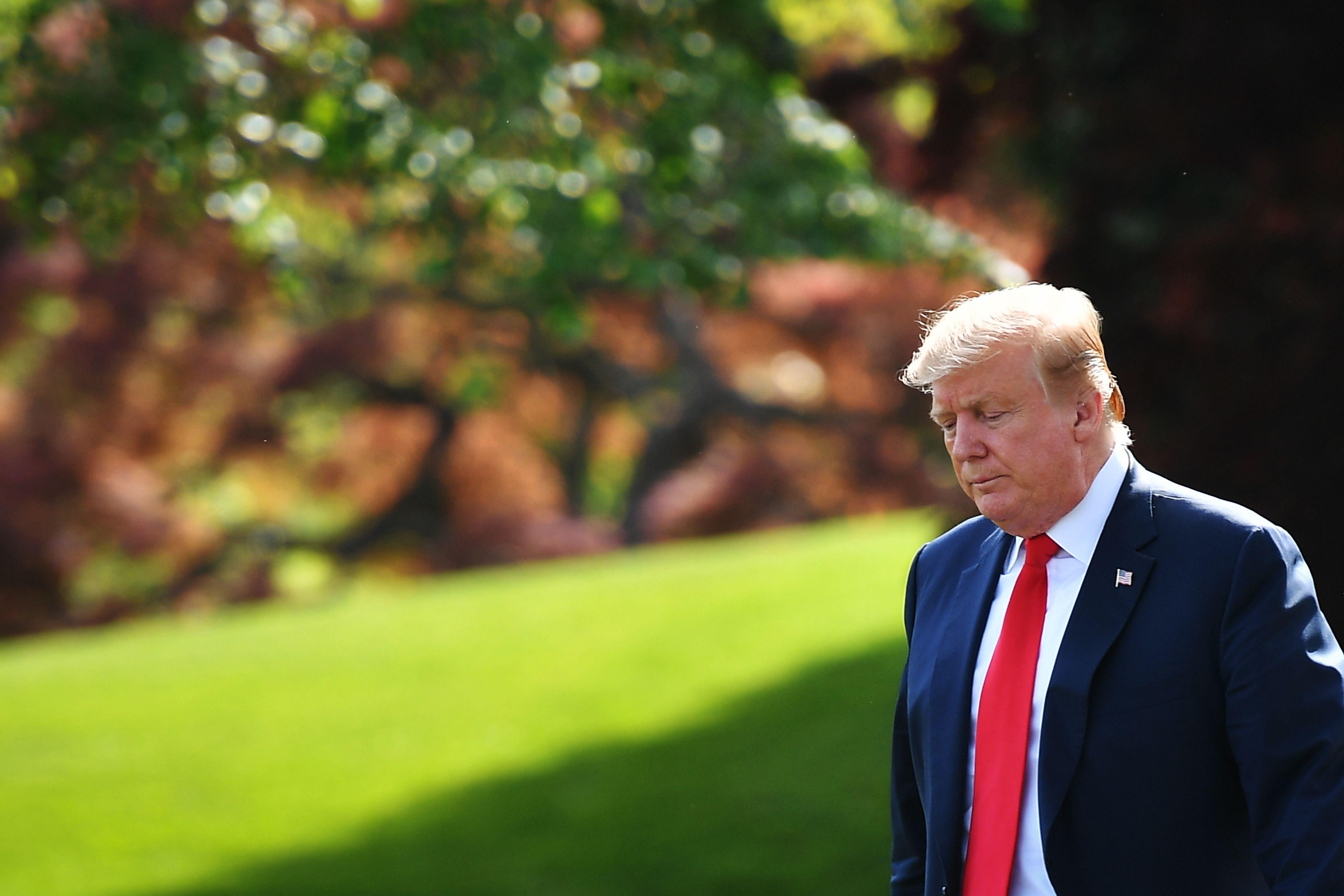 President Donald Trump walks across the South Lawn to board Marine One before departing from the White House in Washington on Thursday.