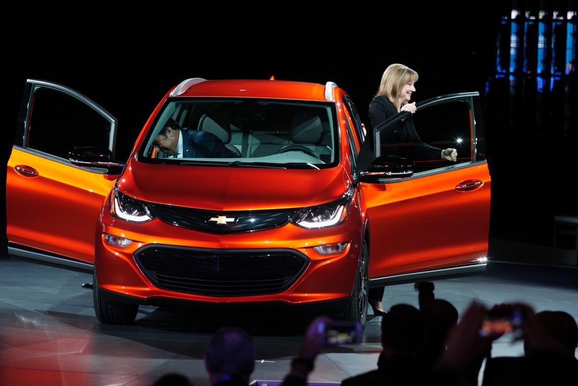 Mary Barra steps out of a Chevy Bolt.