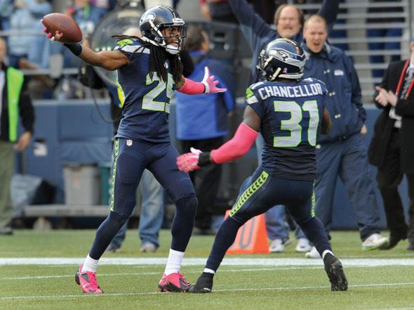  Cornerback Richard Sherman #25 of the Seattle Seahawks celebrates an interception with teammate strong safety Kam Chancellor #31 of the Seattle Seahawks