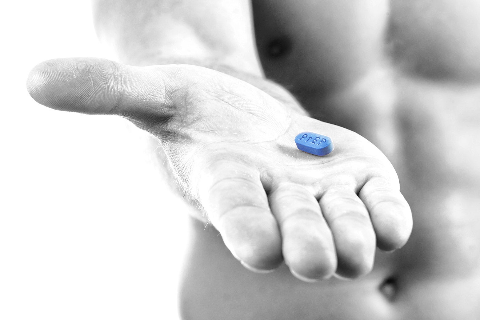 Photo illustration of a shirtless man holding a bright blue PrEP Truvada pill.