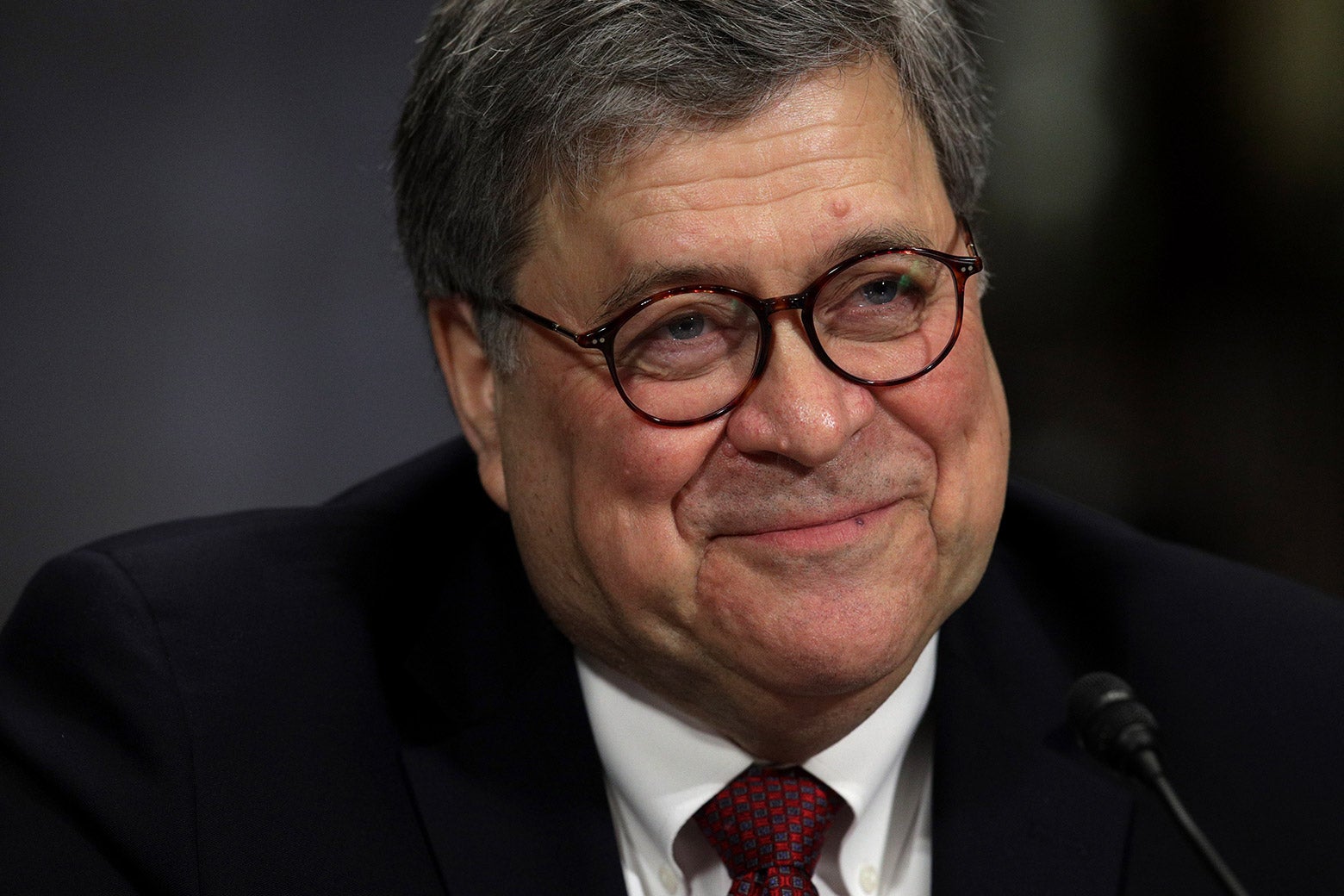 Barr smiling at a mic.