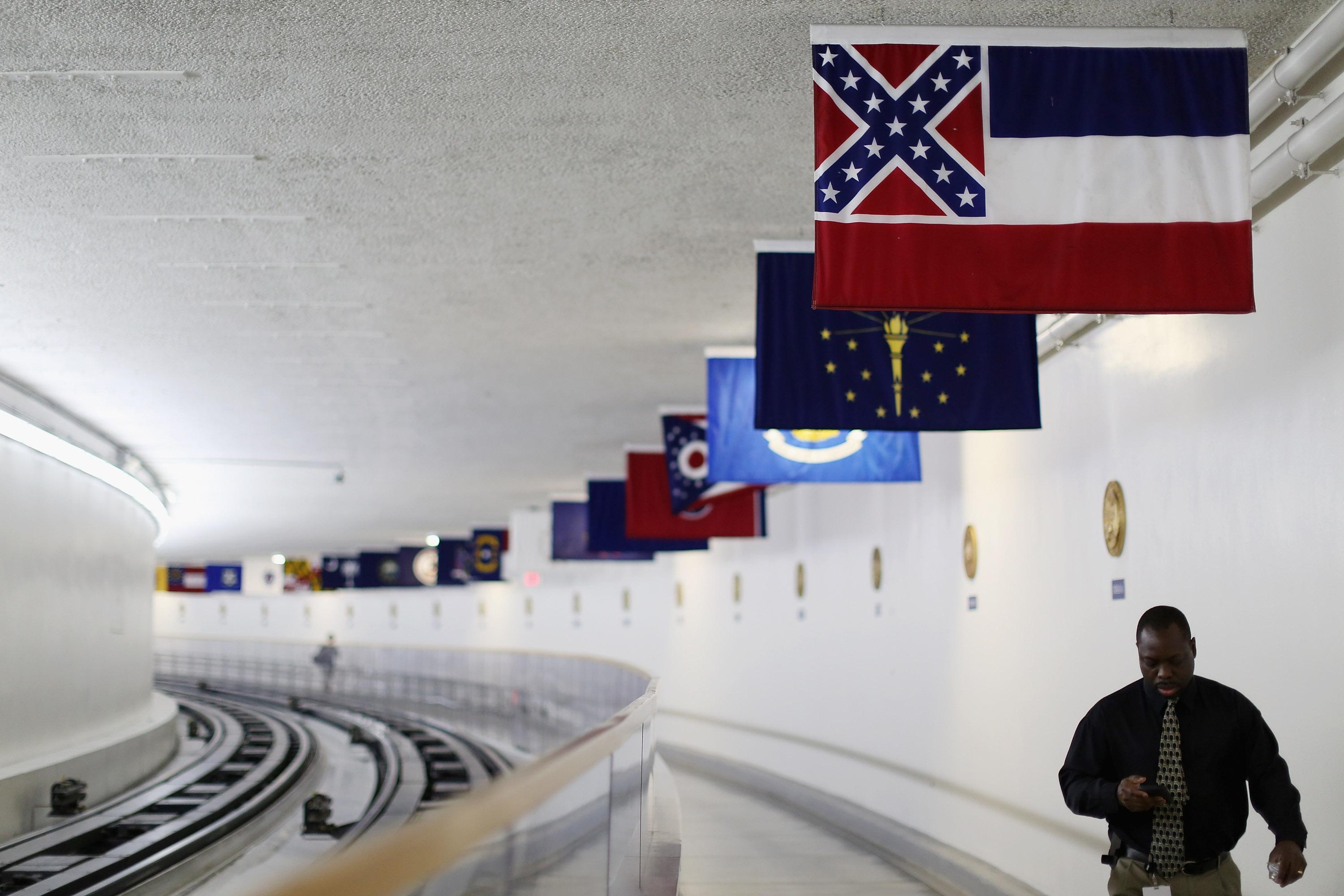 State and territory flags hang from the ceiling of the tunnel, with Mississippi's flag in front