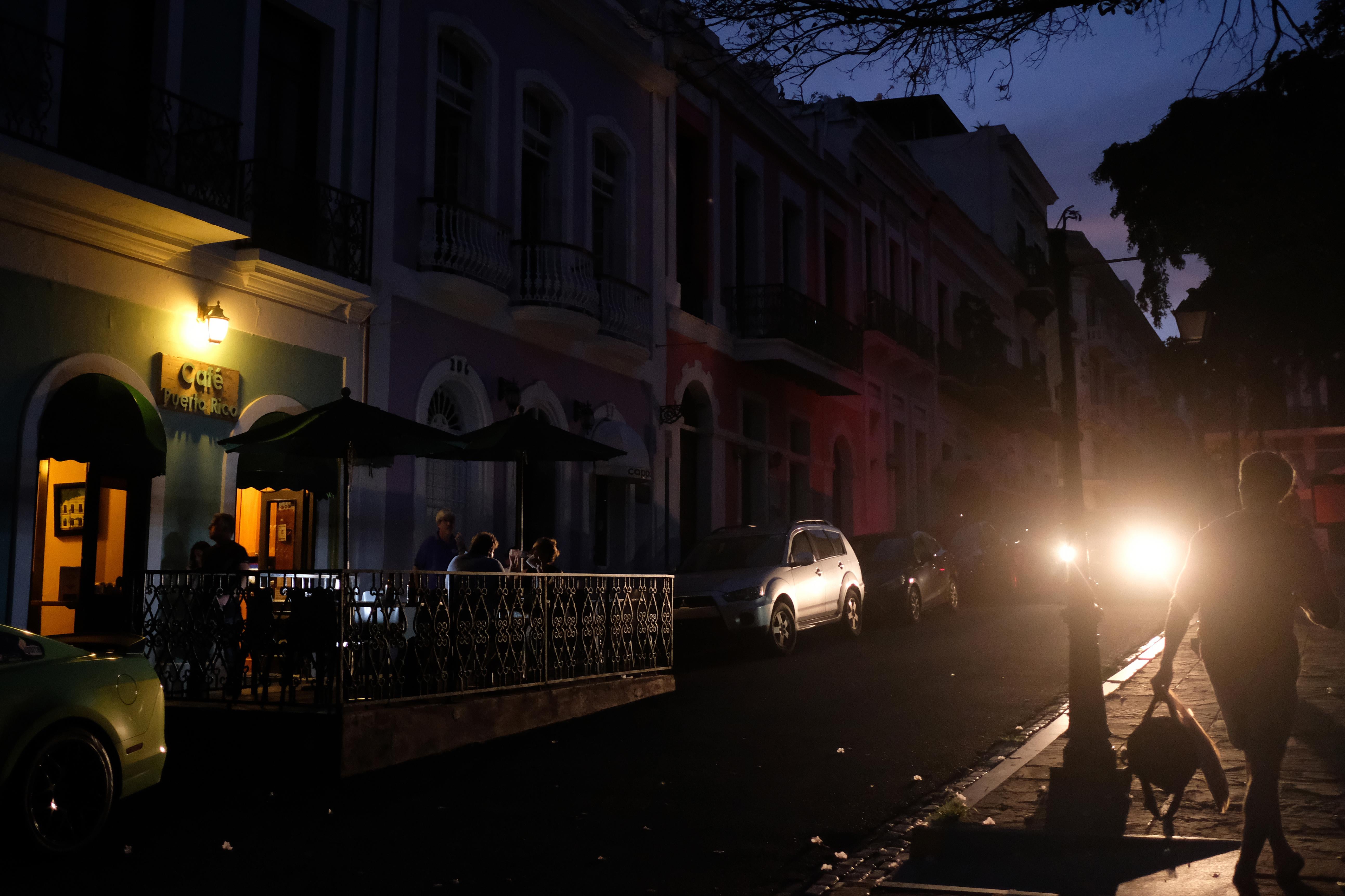 Tourists dine at a darkened sidewalk cafe in Old San Juan, Puerto Rico as a major failure knocked out the electricity in Puerto Rico , leaving the entire island without power nearly seven months after Hurricane Maria destroyed the electrical grid. 