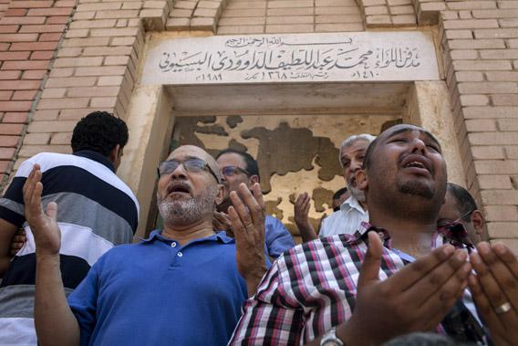 Mourners attend the funeral of Ammar Badie (38), son of the Muslim Brotherhood's Supreme Guide, Mohammed Badie at the Katameya cemetery in the New Cairo.