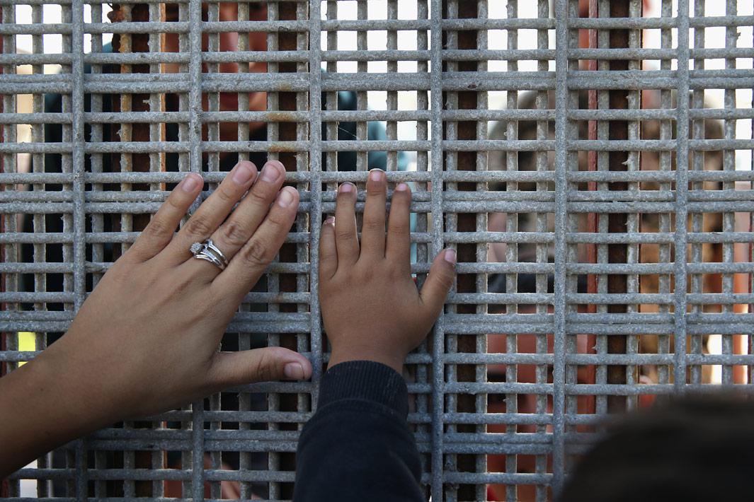 San Diego, Calif. Family members reunite through bars and mesh of the U.S.-Mexico border fence at Friendship Park on November 17, 2013 in San Diego, Calif. The U.S. Border Patrol allows people on the American side to visit with friends and family through the fence on weekends, although under supervision from Border Patrol agents. Access to the fence from the Tijuana, Mexico side is 24/7. Deportation and the separation of families is a major theme in the immigration reform debate. 
