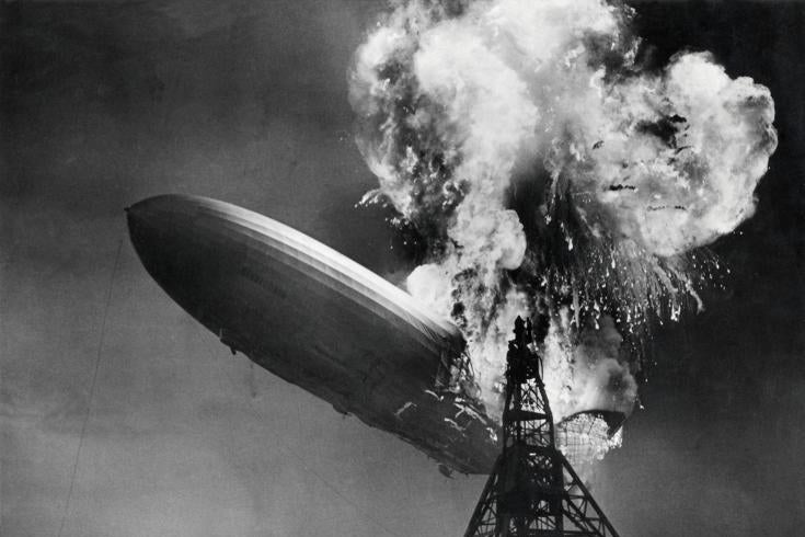 The Hindenburg crashes while engulfed in flames.