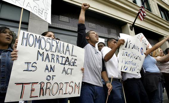 Demonstrators hold sign reading, 'homosexual marriage is an act of terrorism' as they chant slogans against same-sex marriages.