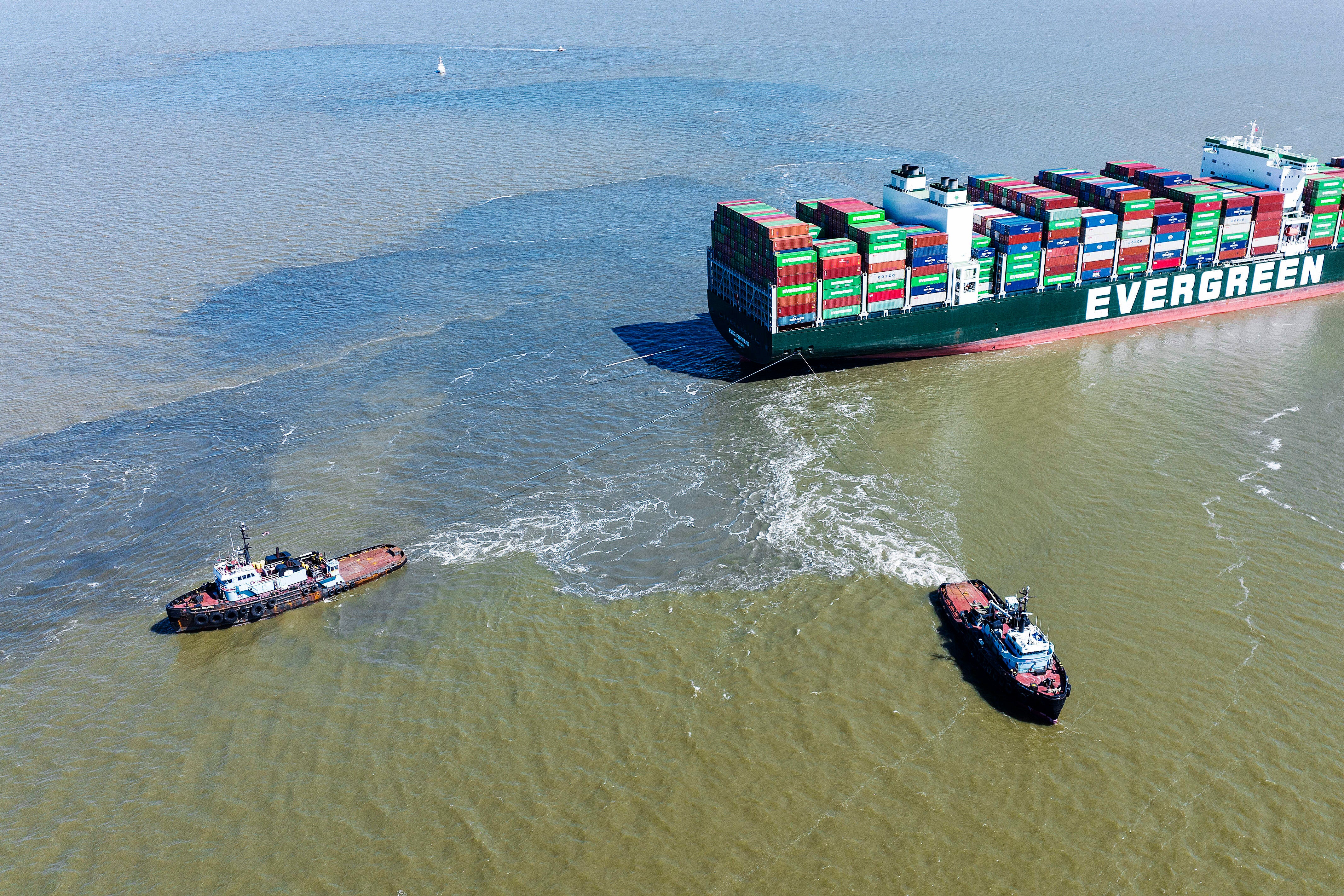A birds-eye view of tugboats pulling on the Ever Forward container ship, which got stuck in the mud in the Chesapeake Bay for over a month.