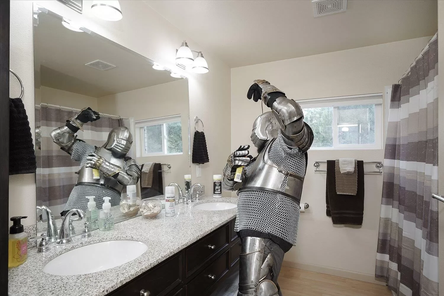 A knight looks at himself in a bathroom mirror, appears to be spraying something under his armpit.