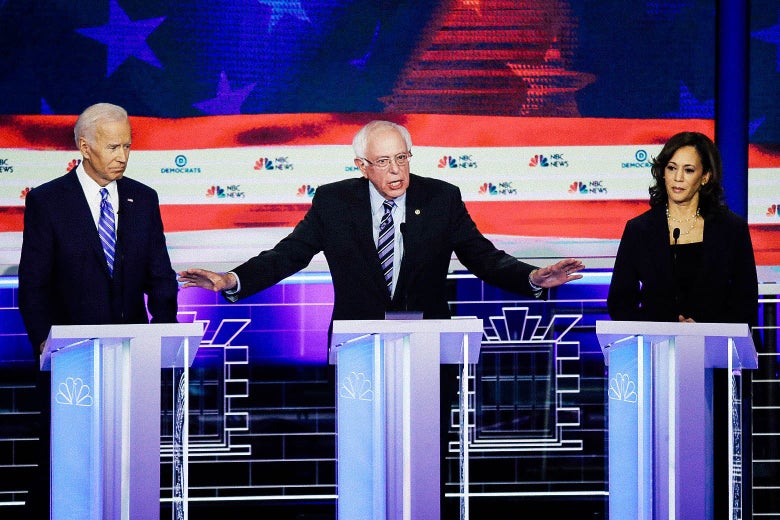 From center, Vermont Sen. Bernie Sanders speaks while former Vice President Joe Biden and Sen. Kamala Harris look on during the second night of the first Democratic presidential debate on Thursday in Miami.