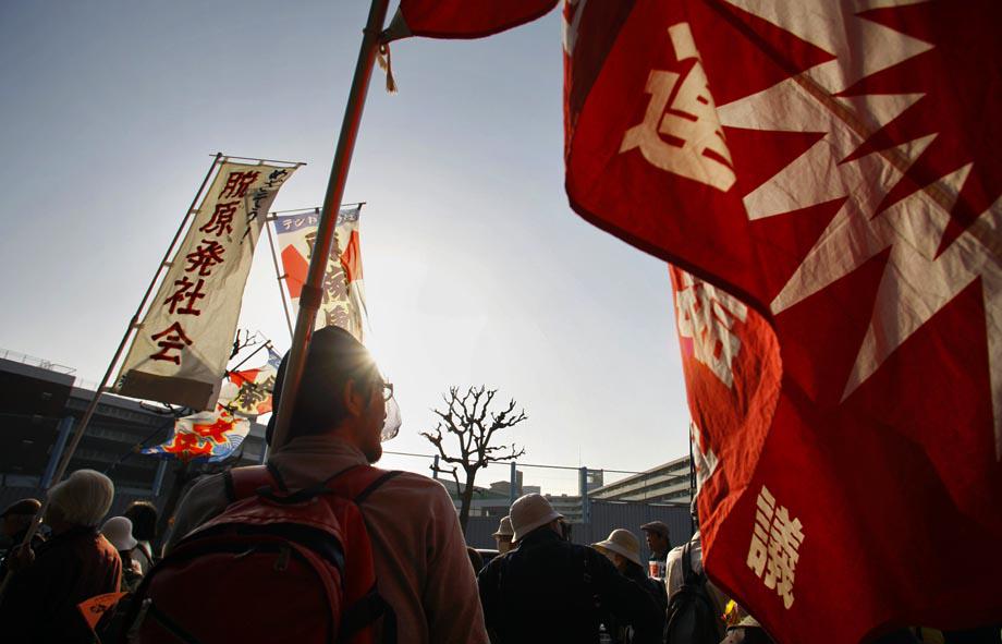 Protesters hold banners and flags during an anti-nuclear demonstration in Tokyo, Saturday, March 9, 2013.