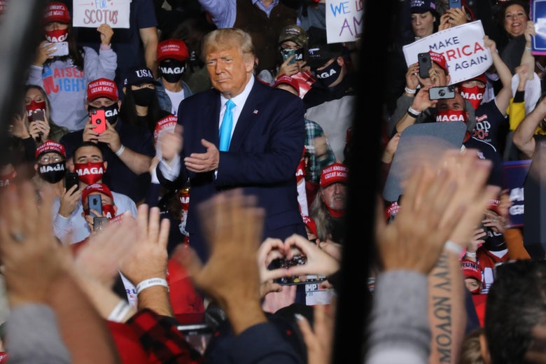 A lot of people with MAGA signs up close and personal with a sick president.
