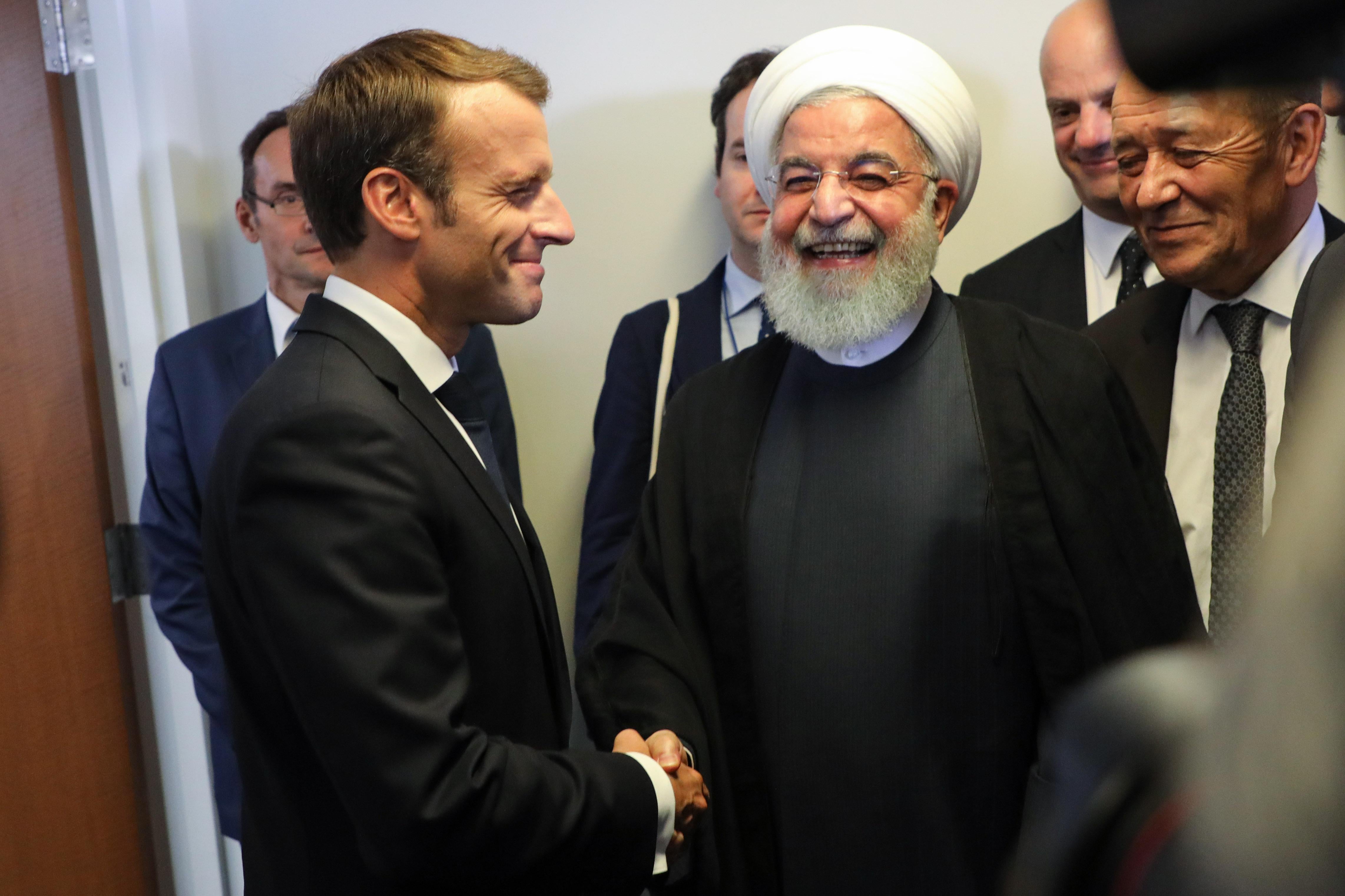 Macron shaking hands with Rouhani.