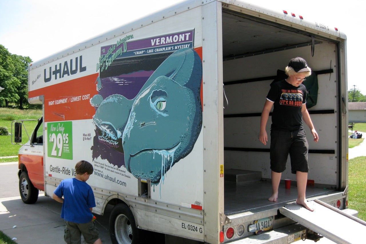 A woman and a boy in a moving van.