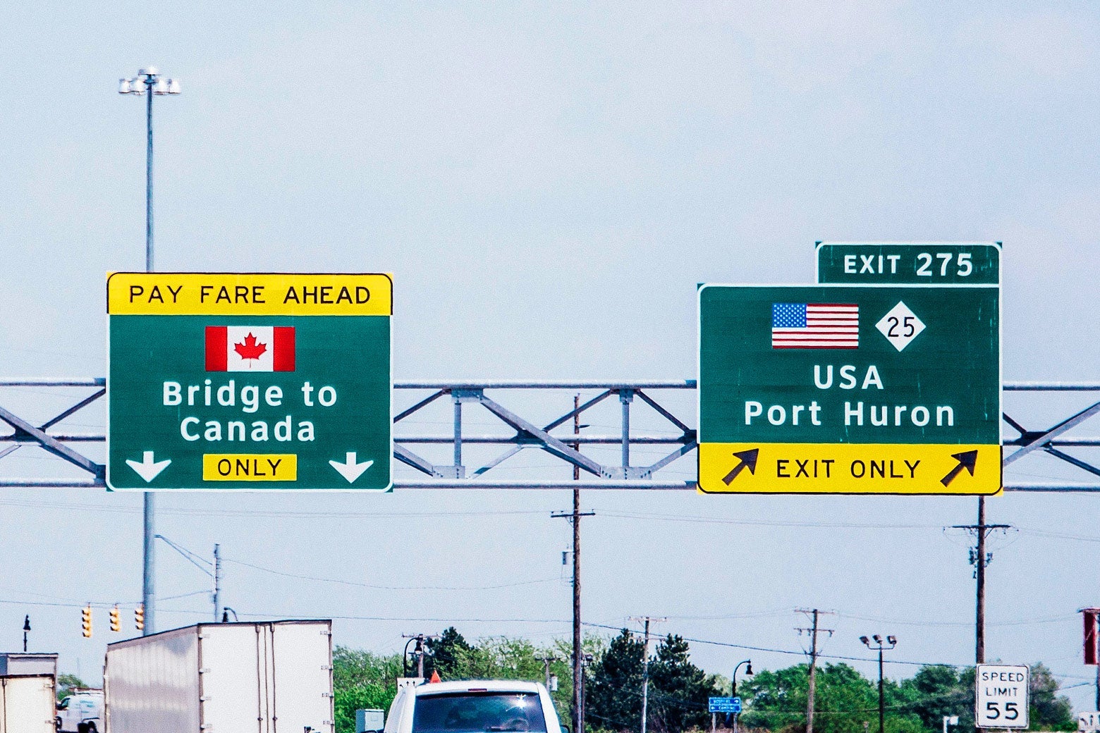 Highway signs show the way to the Bridge of Canada and Port Huron.