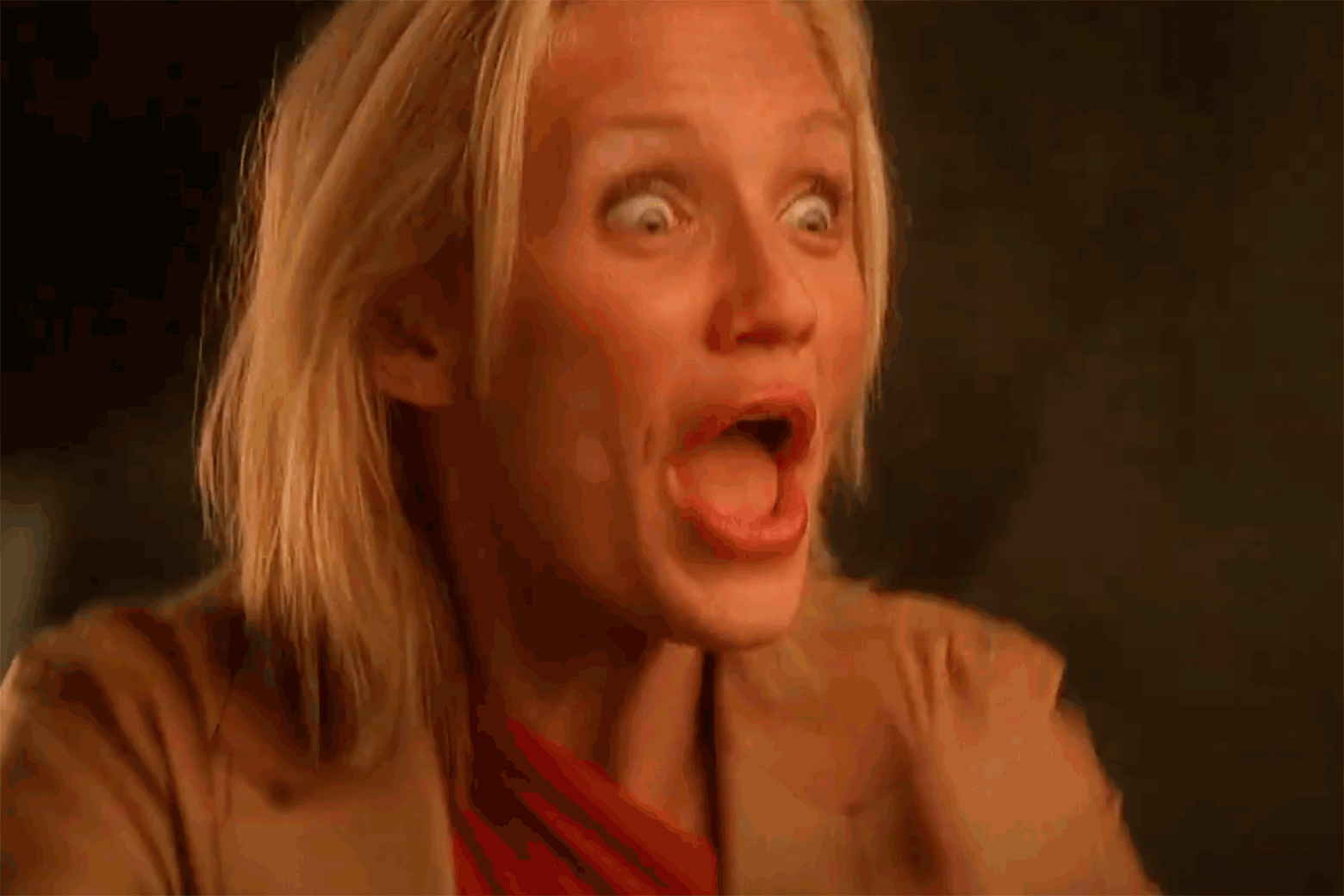 A blond woman whistles into her hands excitedly.