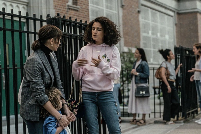 Jenny Slate and Rashida Jones stand outside a school