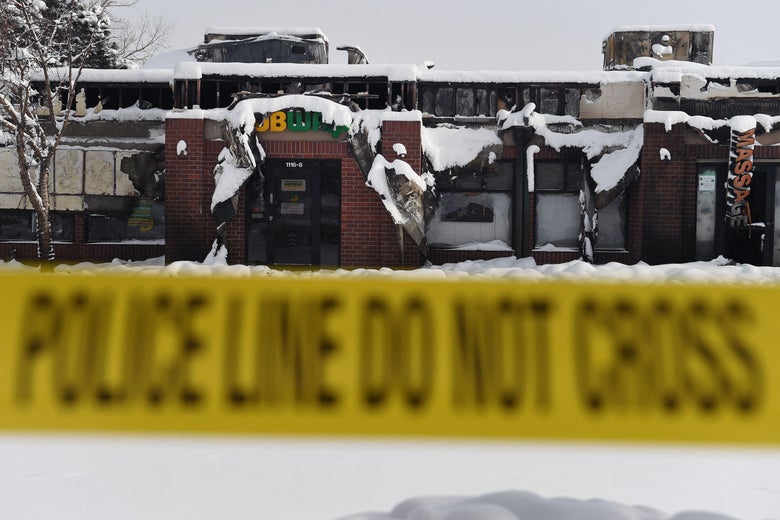 Businesses destroyed by the Marshall Fire in the town of Superior in Boulder County, Colorado are closed off with police tape on January 1, 2022. 