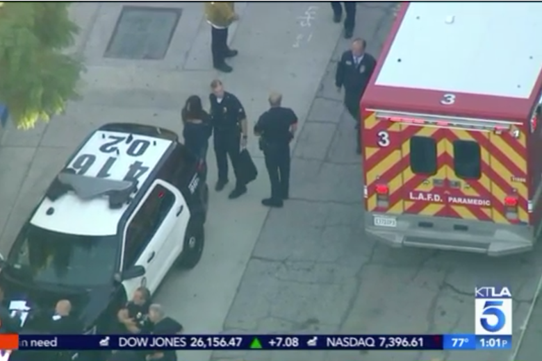 A screen grab from helicopter news footage shows officers leading a handcuffed girl with long hair to a waiting squad car after a shooting at the Salvador Castro Middle School in Los Angeles on Feb. 1, 2018.