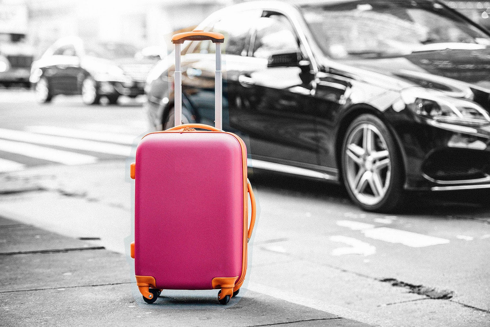An unattended suitcase on a sidewalk.
