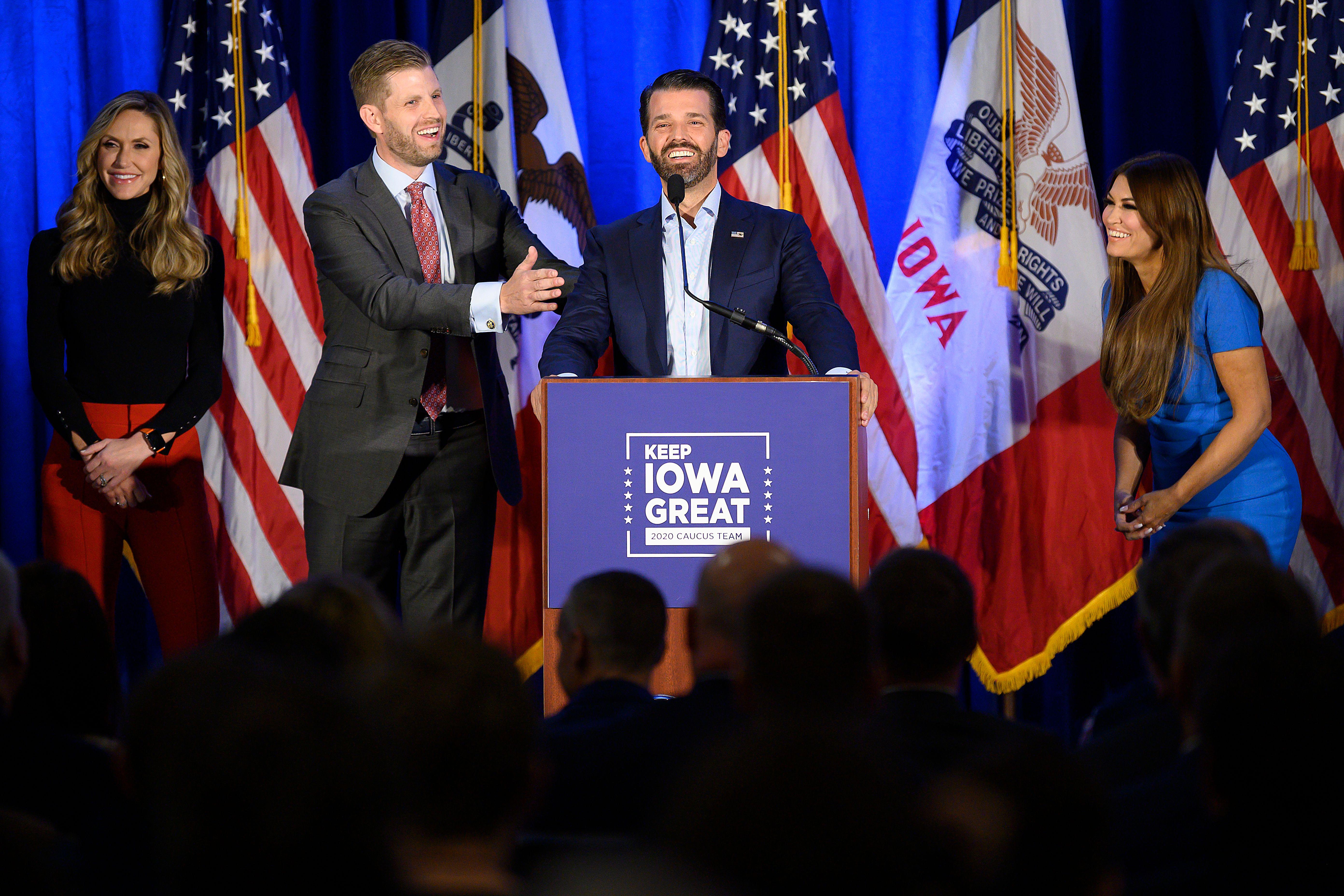 Donald Trump Jr. (C) speaks with his brother Eric (2nd L) and wife Lara, as well as his girlfriend Kimberly Guilfoyle (R) during a "Keep Iowa Great" press conference in Des Moines, IA, on February 3, 2020. 