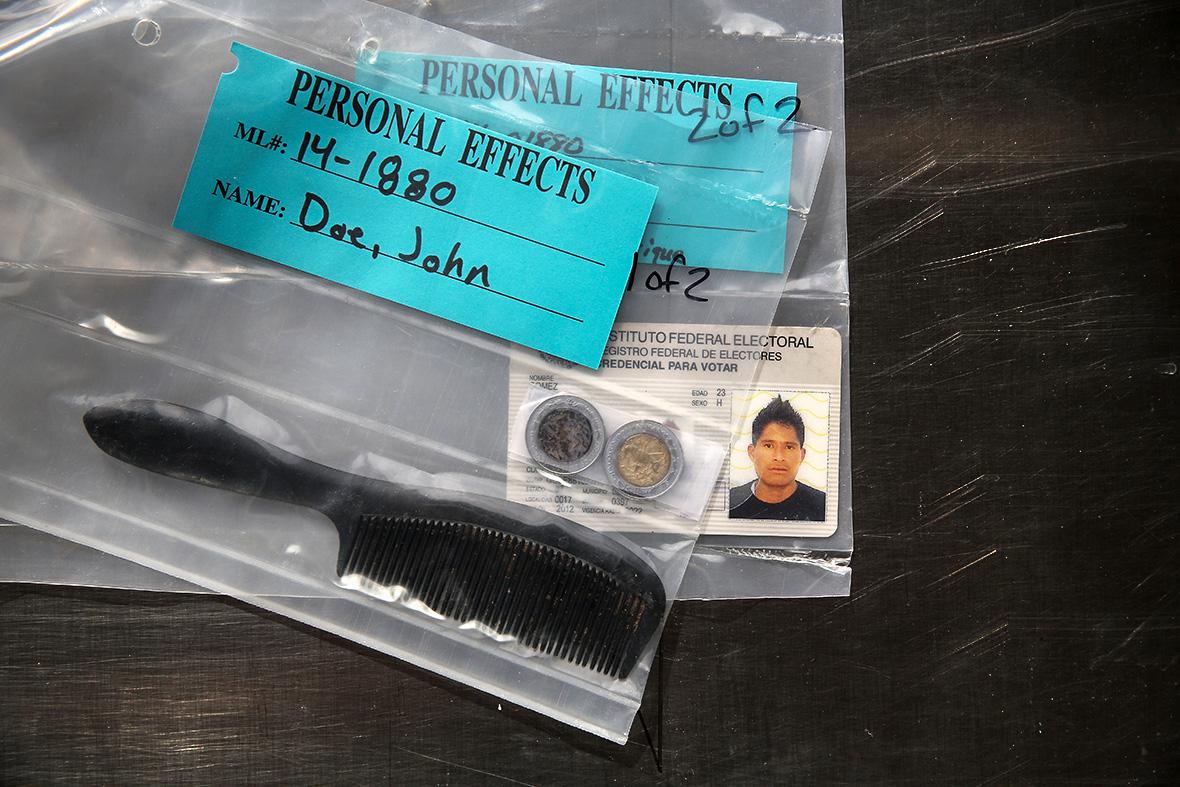 A comb, change and a Mexican identification card are kept in a sealed bag of personal effects at the Pima County Office of the Medical Examiner on Dec. 9, 2014. The items were found with the decomposed remains of a Mexican male, 25, found in the Arizona desert on Aug. 1, 2014. 