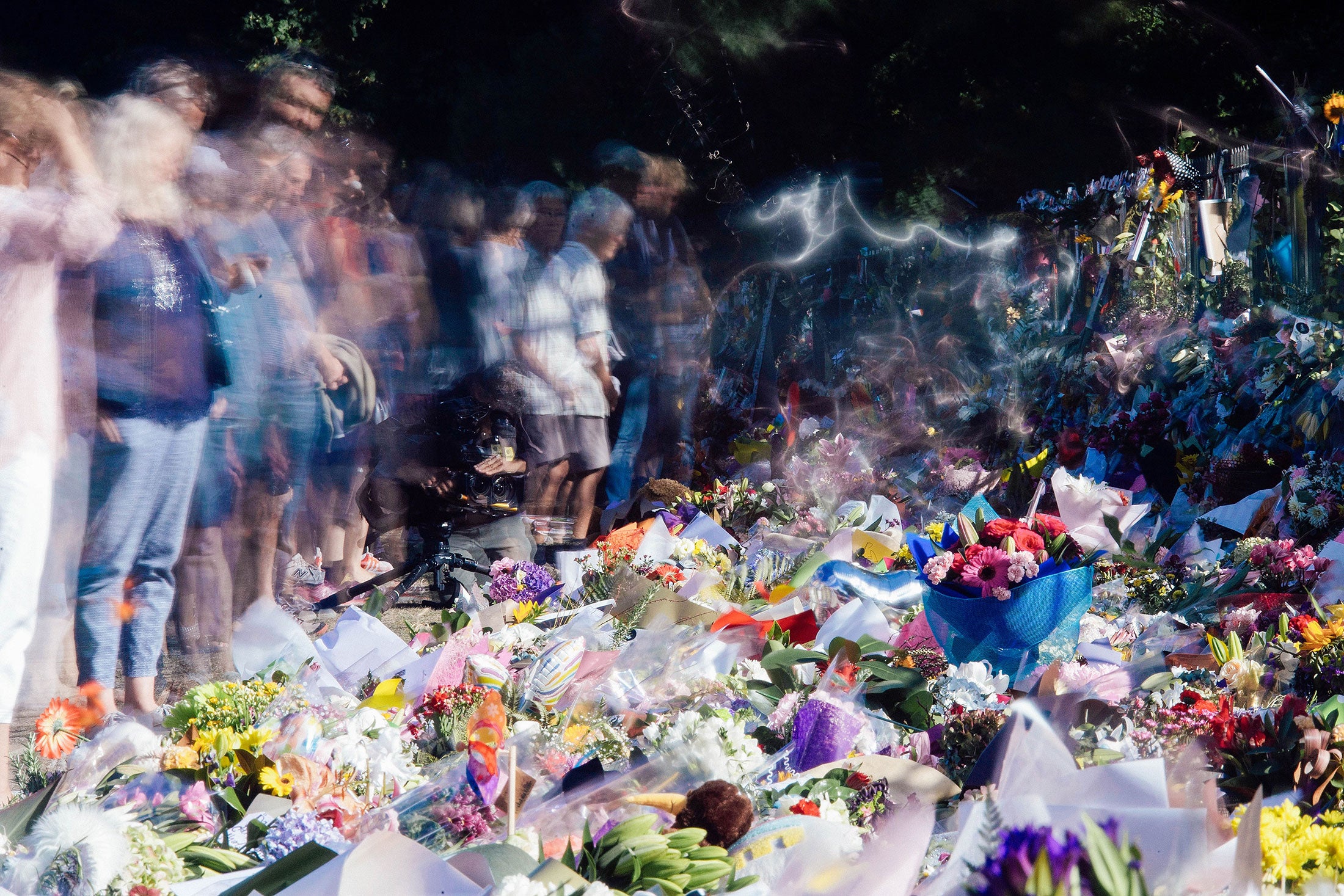 Mourners gathered in front of floral tributes to the New Zealand shooting victims.
