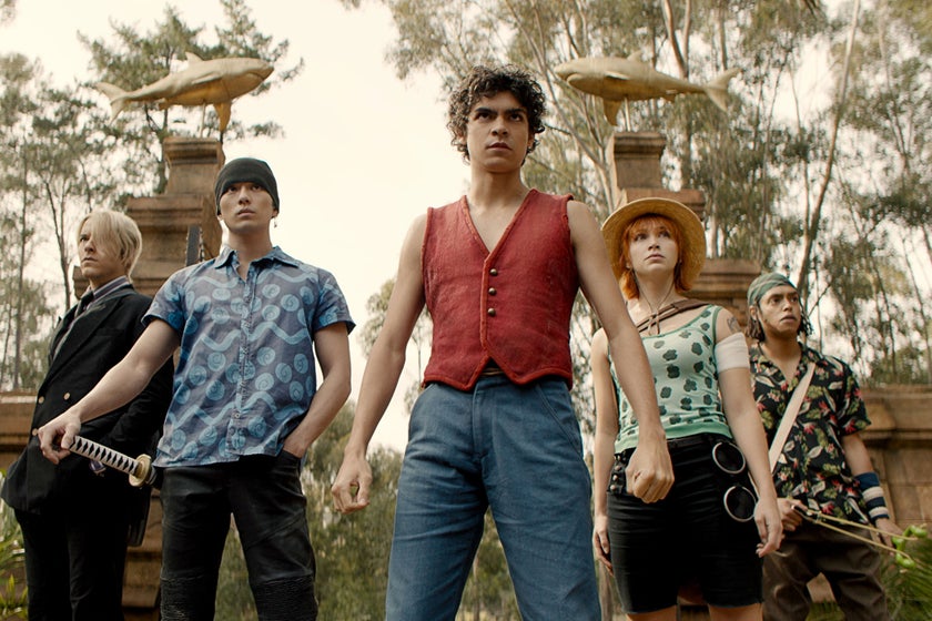 A promotional still of Netflix's live-action One Piece with the five main characters standing in a triangle formation as they stare forward.