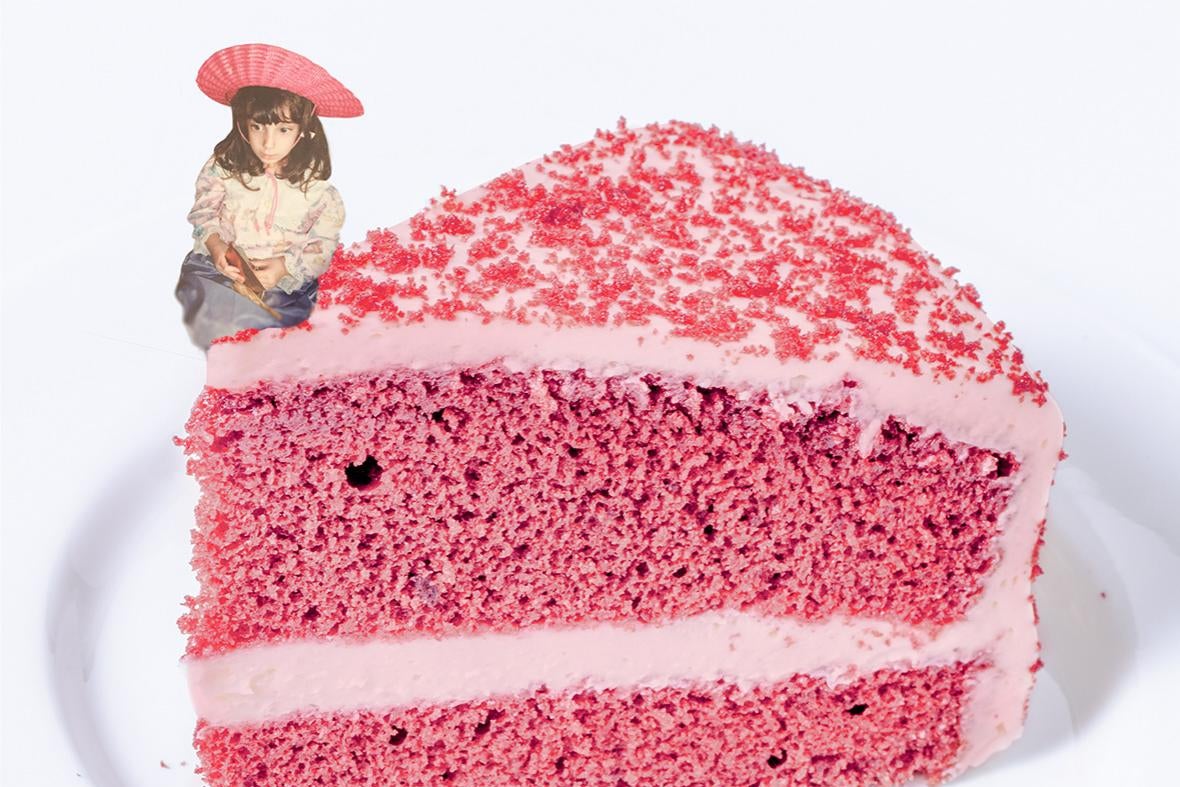 A girl sitting on a slice of cake