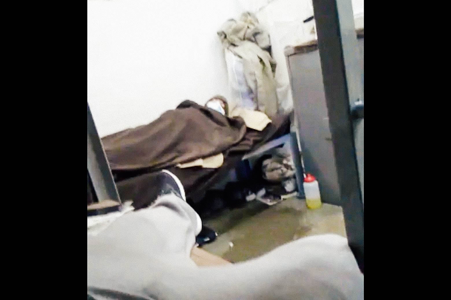 A blurry image of a man in a bed with a mask on.