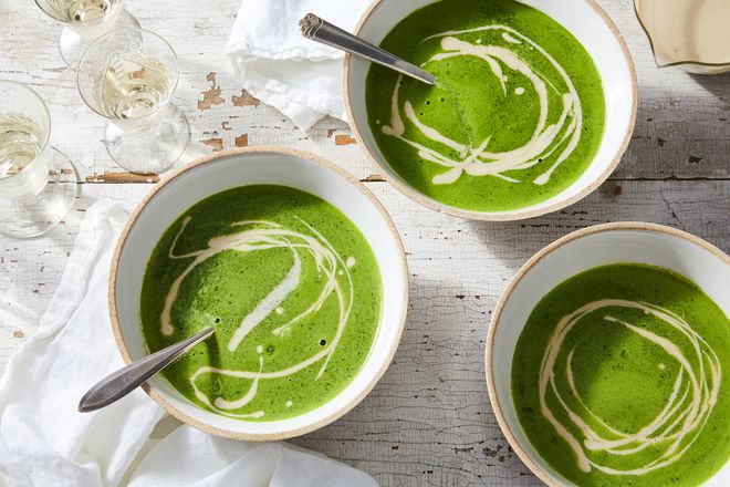 Three bowls of green liquid with swirls of white.