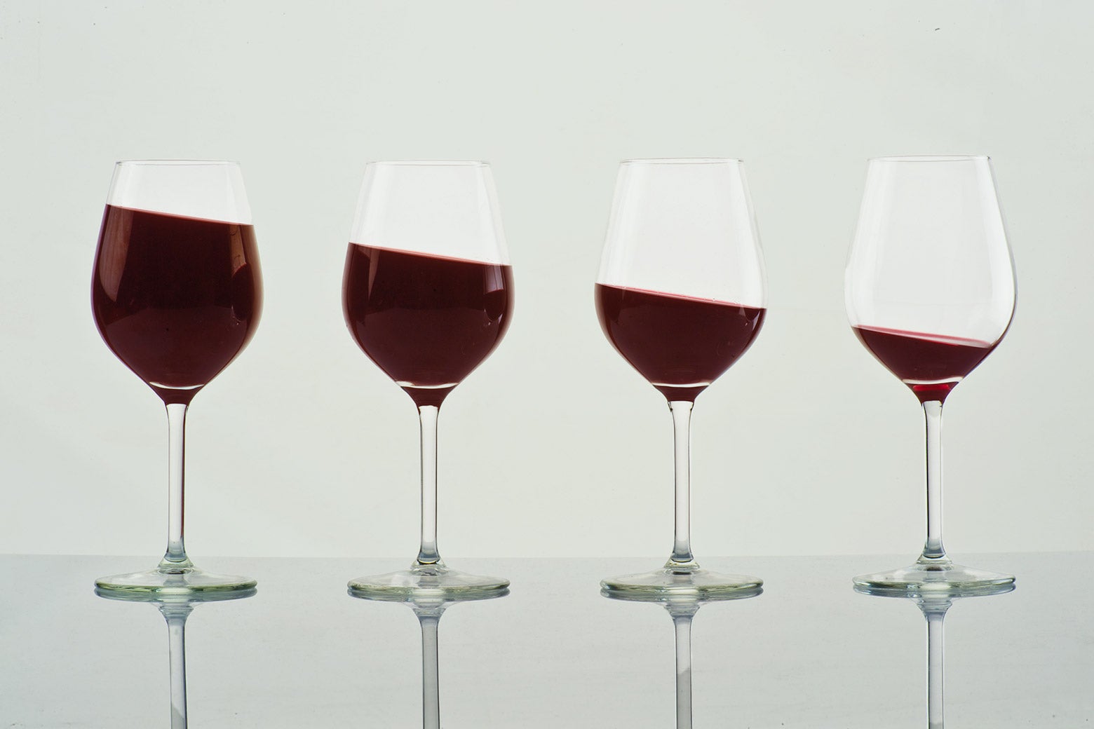 A group of four wineglasses, with each holding less wine than the last.