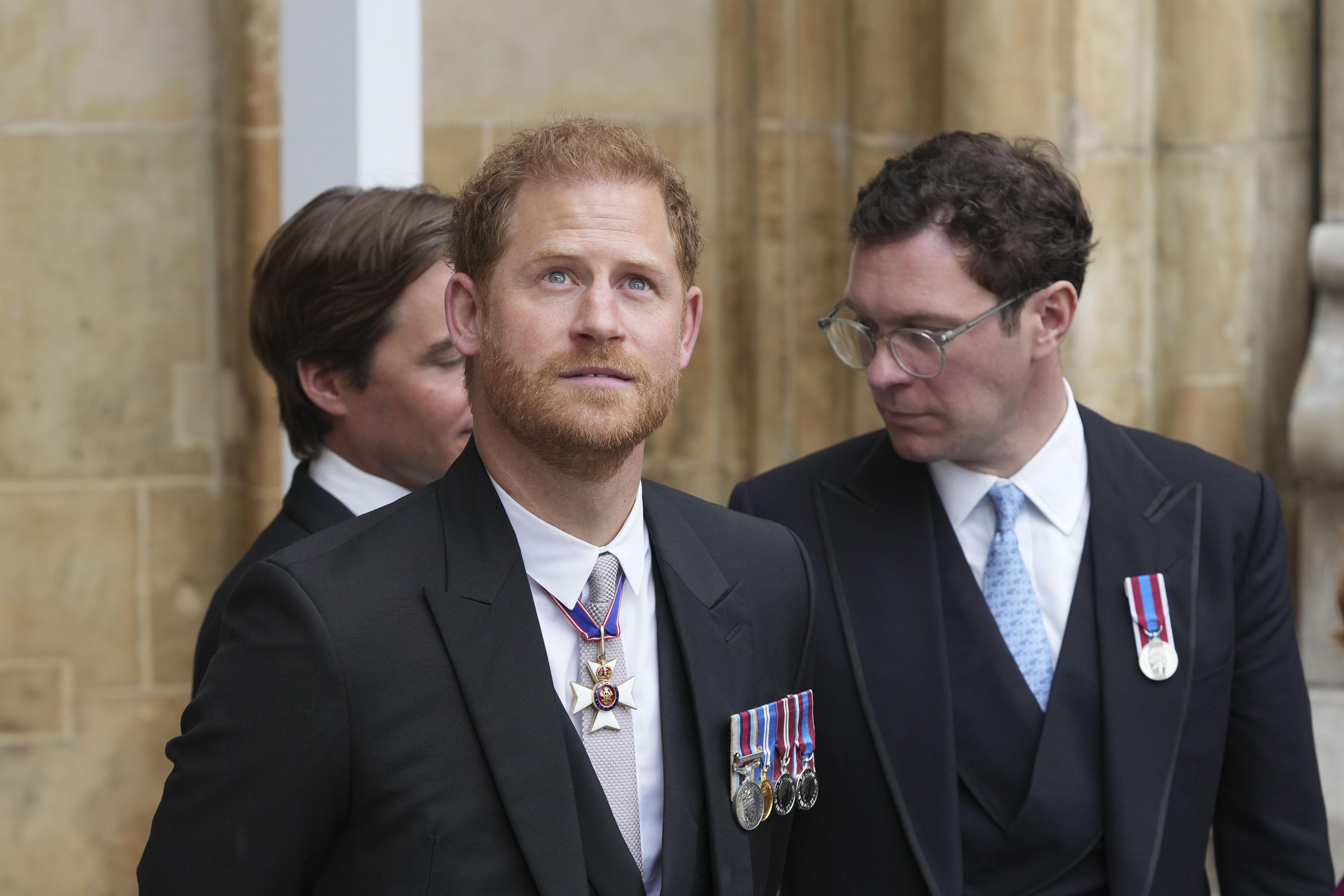 Prince Harry looks at the sky.