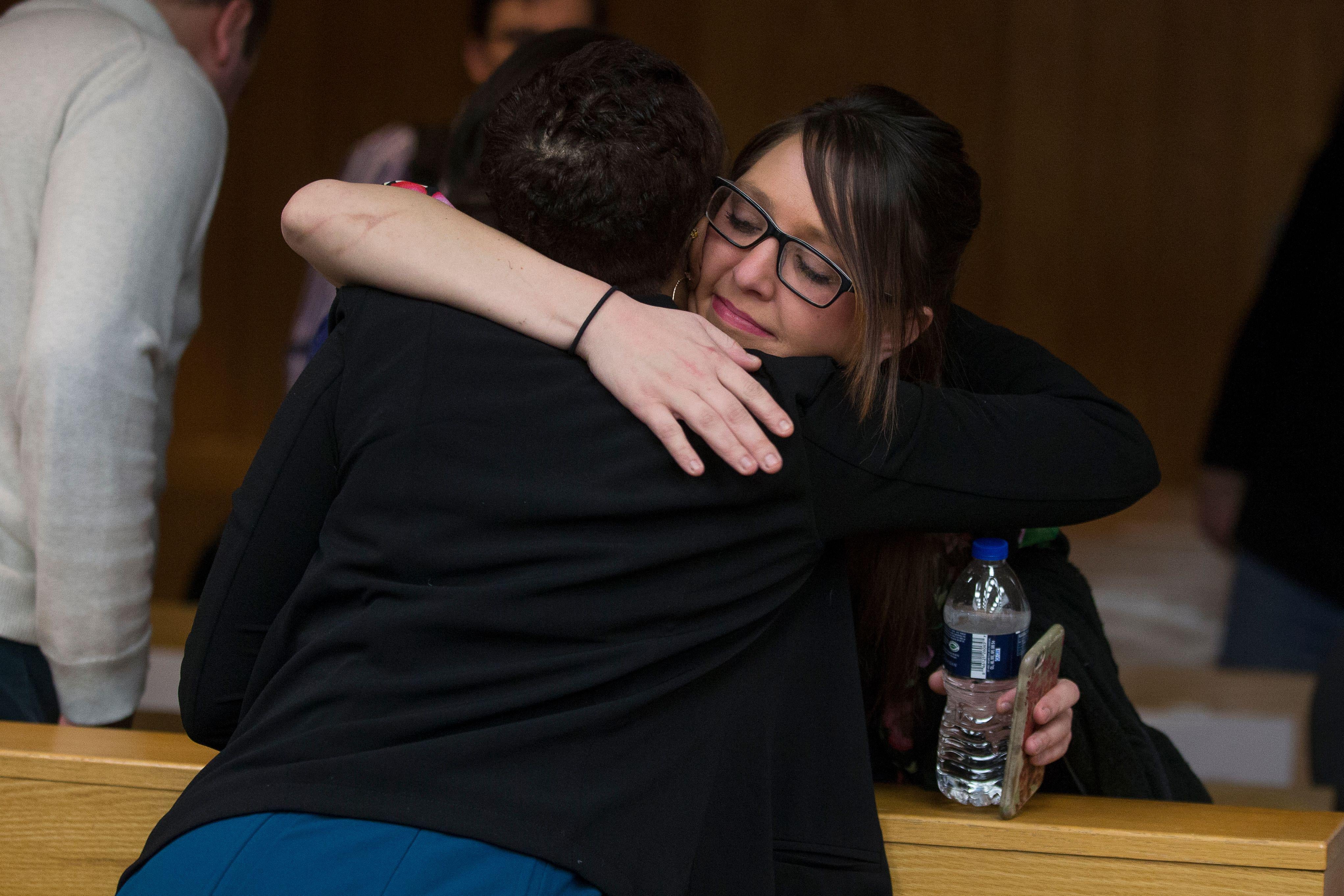Assistant Attorney General Robyn Liddell, left, hugs Nassar victim Ashley Erickson.