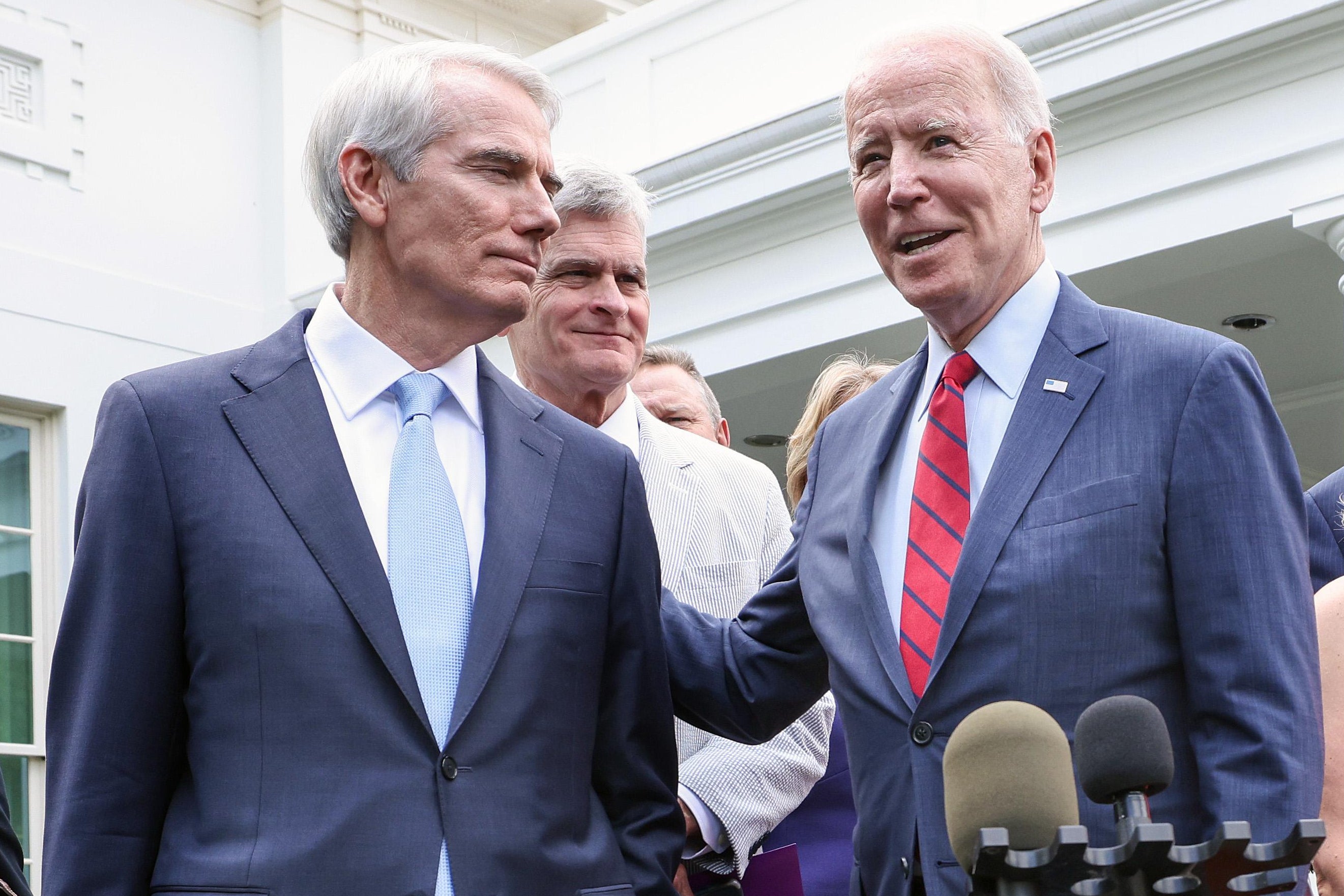 President Joe Biden puts his arm on Sen. Rob Portman (R-OH) as he speaks after the bipartisan group of Senators reached a deal on an infrastructure package at the White House on June 24, 2021 in Washington, D.C.